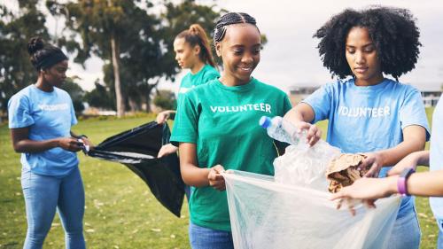 Students, recycle and community volunteer project with young people cleaning plastic and trash. Happy, recycling and charity work for a sustainability, eco friendly and ecology service outdoor